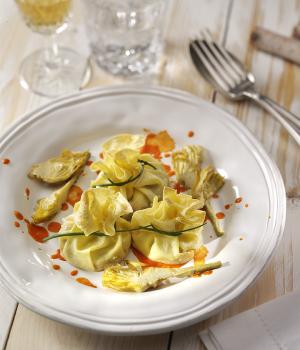 Egg pasta basket with stracciatella cheese, artichokes and tomato coulis