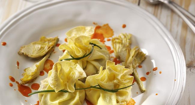 Egg pasta basket with stracciatella cheese, artichokes and tomato coulis