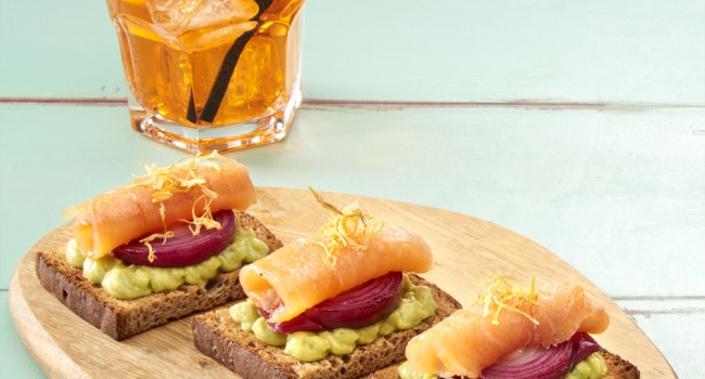 MULTIGRAIN CROSTINI WITH GUACAMOLE, SWEET AND SOUR RED ONION AND SMOKED SALMON