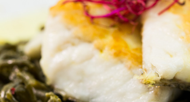 Darne of sea bass with saffron sauce served on a bed of samphire
