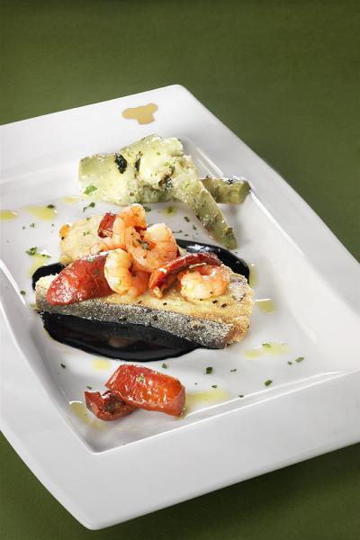 Pieces of swordfish with squid ink, shrimps, Soleggiati Sun Blushed Tomatoes and grilled artichokes