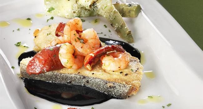 Pieces of swordfish with squid ink, shrimps, Soleggiati Sun Blushed Tomatoes and grilled artichokes