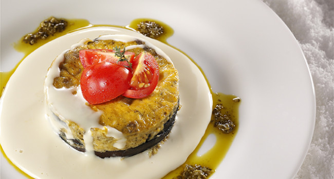 Eggplant flan with basil pesto and parmigiano cheese sauce