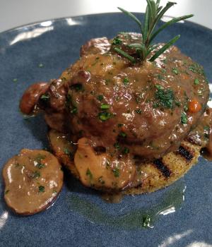 Braised pork cheek with sangiovese, mushrooms, served with rosemary  rustic polenta