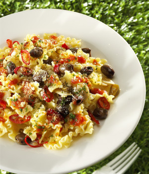 Spicy mafalde pasta with black olives and toasted breadcrumbs