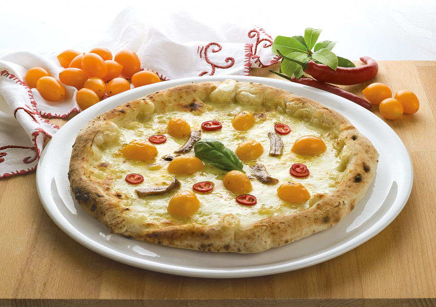 Tasty Pizza with yellow tomatoes and anchovies