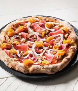 Pizza with yellow cherry tomatoes and black angus