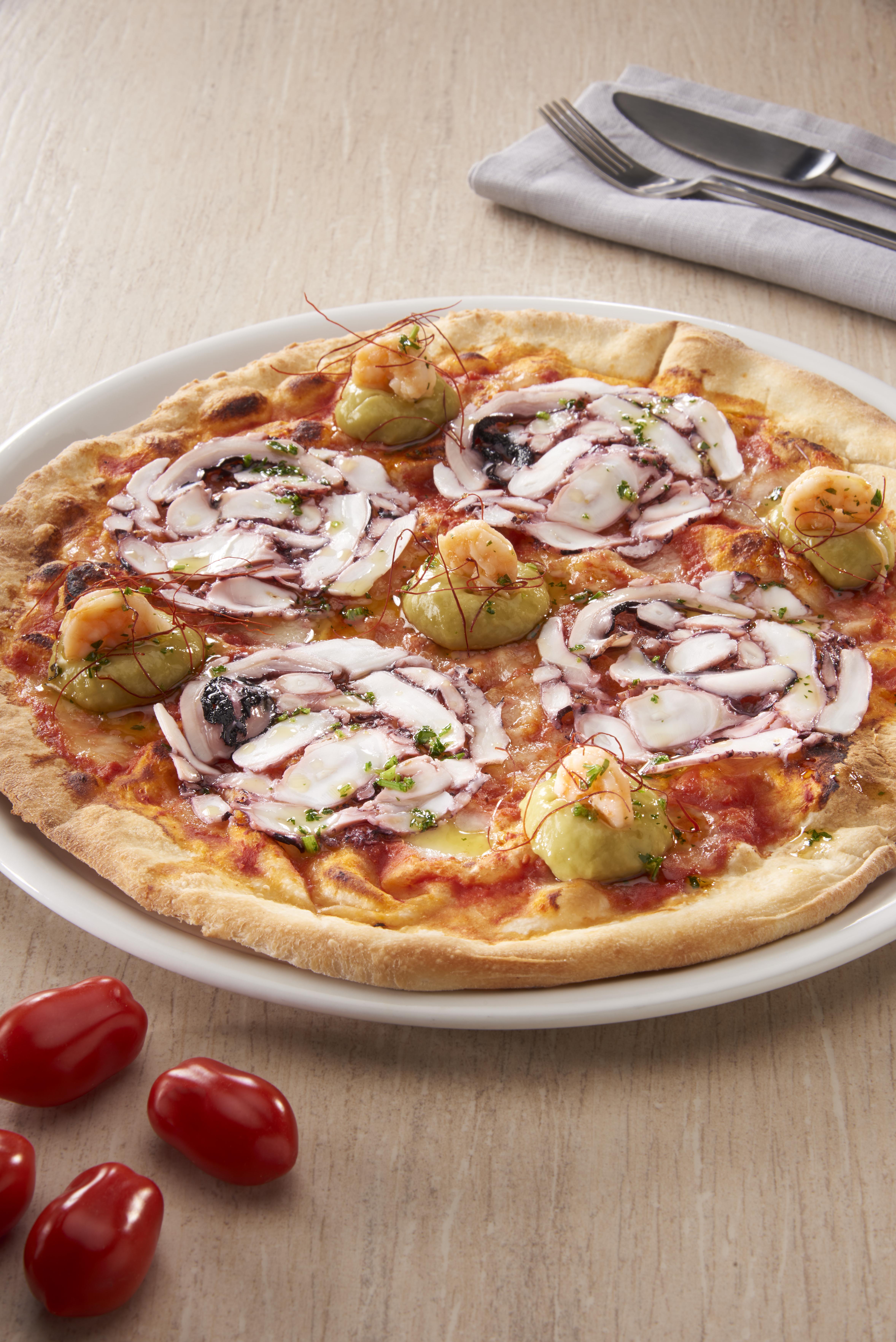 Pizza with pranws, octopus carpaccio, guacamole and chili threads