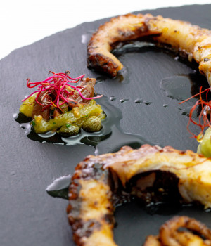 Spicy octopus with guacamole sauce and Mini Yellow tomatoes