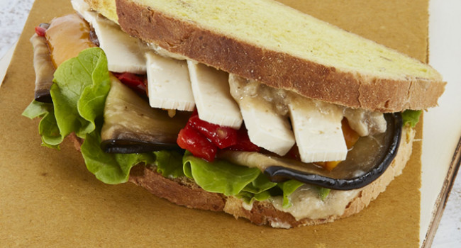 Vegan pumpkin bread sandwich with vegetables and tofu
