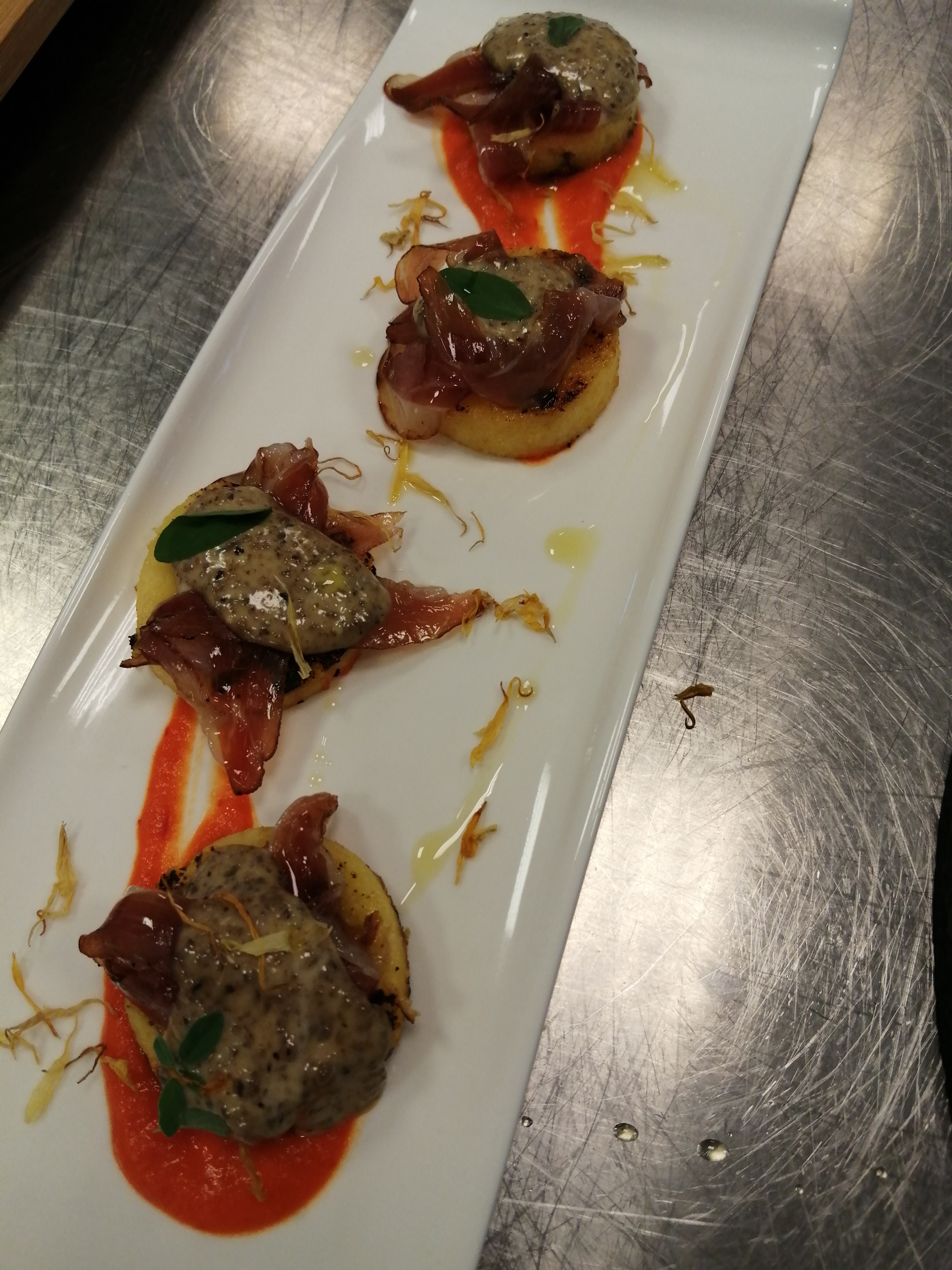 Polenta bites with black olive mayo  smoked goose and peperonata coulis