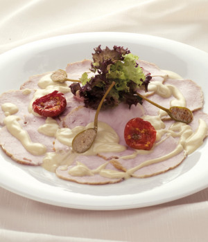 Veal with tuna sauce and caper berries